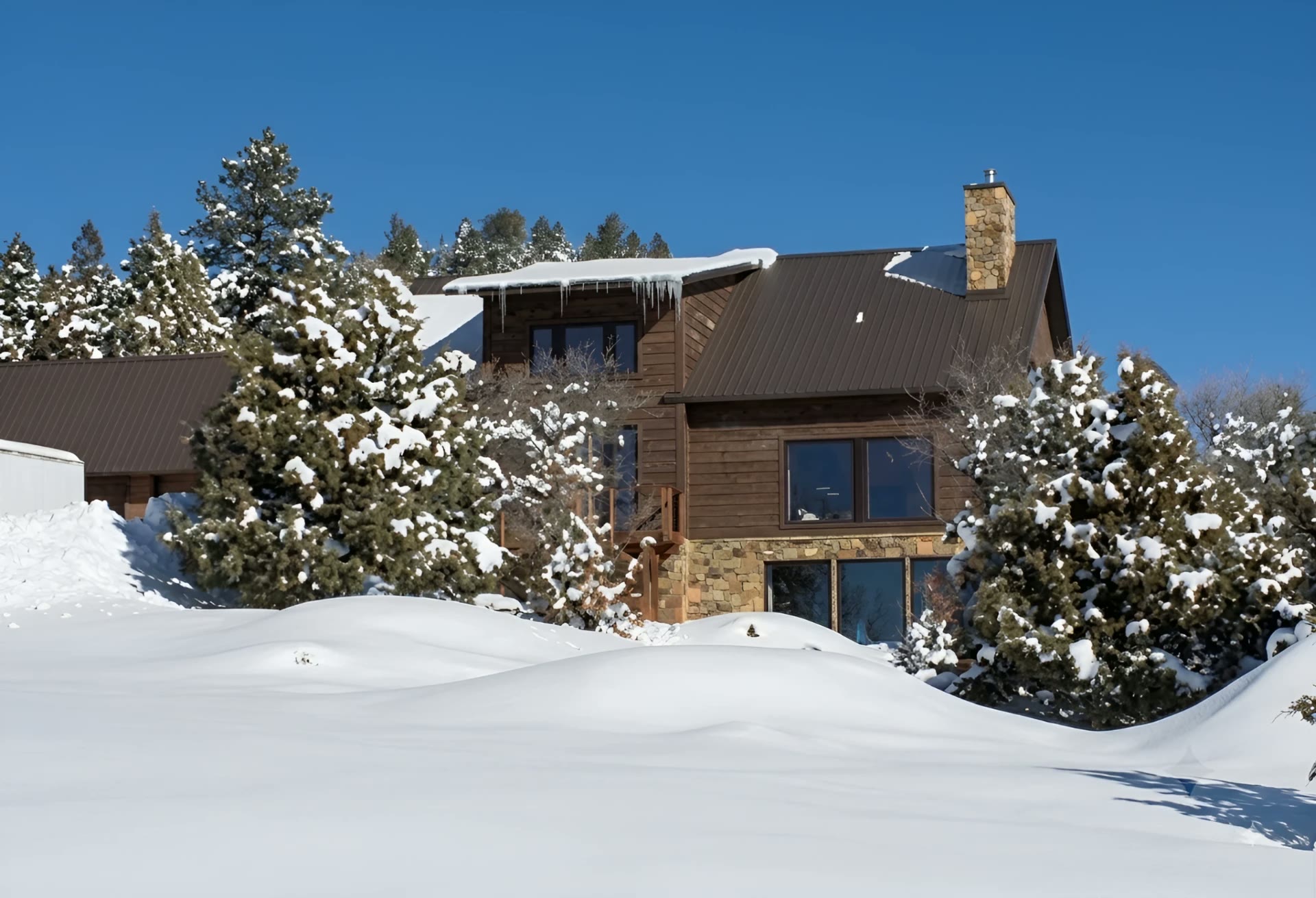 Pagosa Springs passive solar house in deep winter snow with south-facing glazing